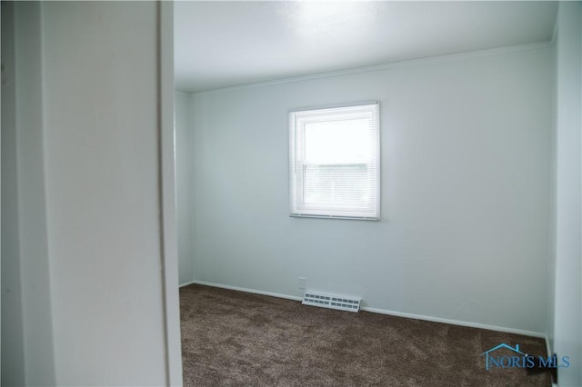 1474 S Clinton St, Defiance, OH 43512 - unfurnished room with dark colored carpet and crown molding