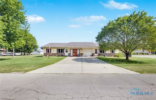 304 Fulton St, Fayette, OH 43521 - ranch-style house featuring an attached garage, a front yard, concrete driveway, and brick siding