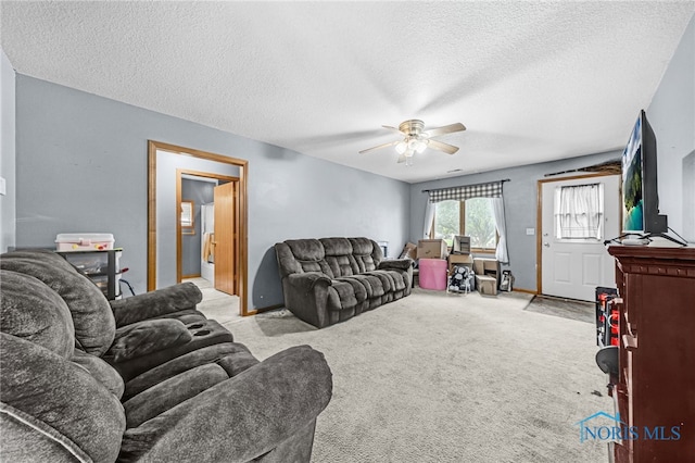 304 Fulton St, Fayette, OH 43521 - living room with a ceiling fan, a textured ceiling, and light colored carpet
