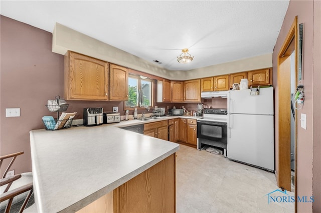 304 Fulton St, Fayette, OH 43521 - kitchen with freestanding refrigerator, electric stove, under cabinet range hood, light countertops, and a peninsula