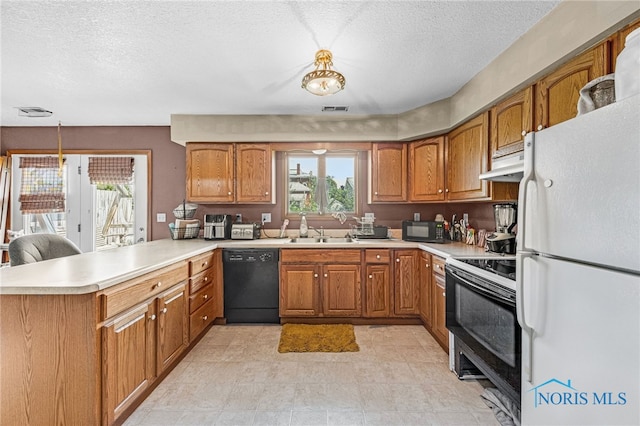 304 Fulton St, Fayette, OH 43521 - kitchen featuring black appliances, under cabinet range hood, brown cabinetry, light countertops, and a textured ceiling