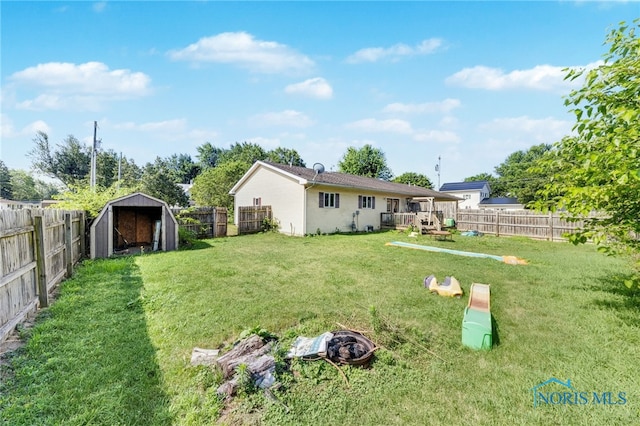 304 Fulton St, Fayette, OH 43521 - rear view of house with a fenced backyard, a storage unit, and a deck