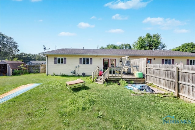 304 Fulton St, Fayette, OH 43521 - rear view of property featuring a fenced backyard, a wooden deck, and a storage unit