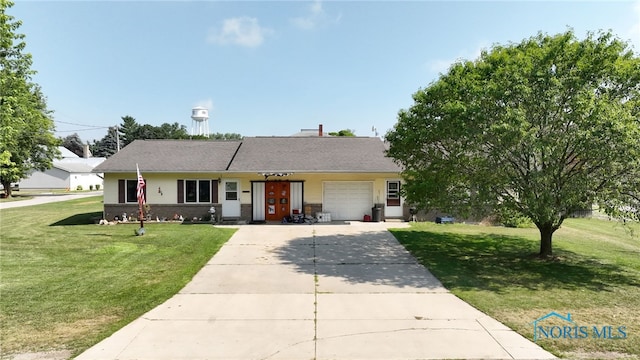 304 Fulton St, Fayette, OH 43521 - single story home with a front lawn, concrete driveway, a garage, and brick siding