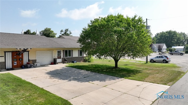 304 Fulton St, Fayette, OH 43521 - view of front of home featuring an attached garage, a front yard, and driveway