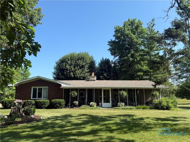 19445 Powers Rd, Defiance, OH 43512 - ranch-style home featuring a sunroom, a front lawn, and a chimney