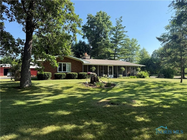 19445 Powers Rd, Defiance, OH 43512 - view of front of house featuring a front yard, a sunroom, and a chimney