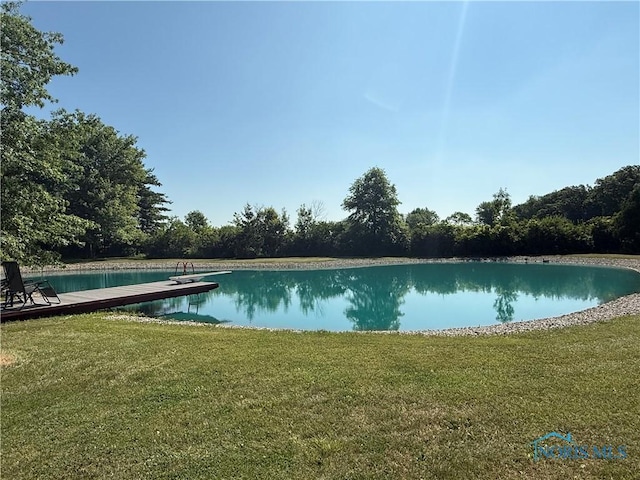 19445 Powers Rd, Defiance, OH 43512 - view of swimming pool featuring a yard, a water view, and an infinity pool