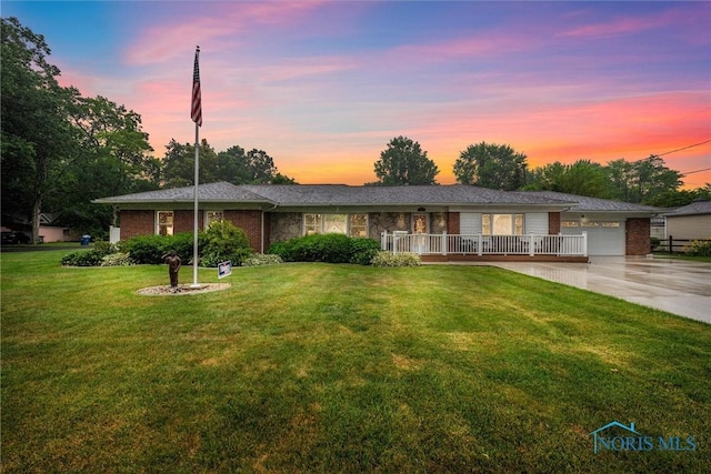 3605 W Laskey Rd, Toledo, OH 43623 - single story home featuring driveway, a yard, a garage, stone siding, and covered porch