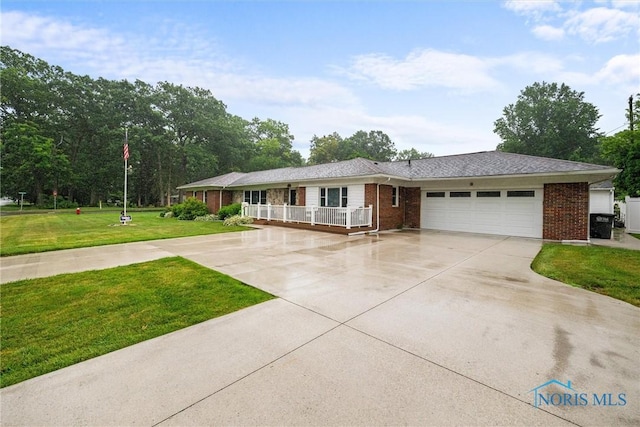 3605 W Laskey Rd, Toledo, OH 43623 - single story home featuring an attached garage, brick siding, driveway, and a front lawn