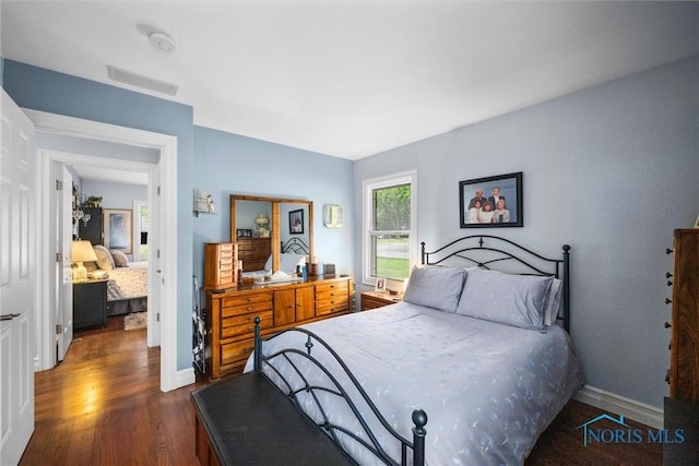 3605 W Laskey Rd, Toledo, OH 43623 - bedroom featuring dark wood-type flooring and baseboards