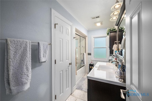 3605 W Laskey Rd, Toledo, OH 43623 - bathroom with vanity, combined bath / shower with glass door, and a textured wall