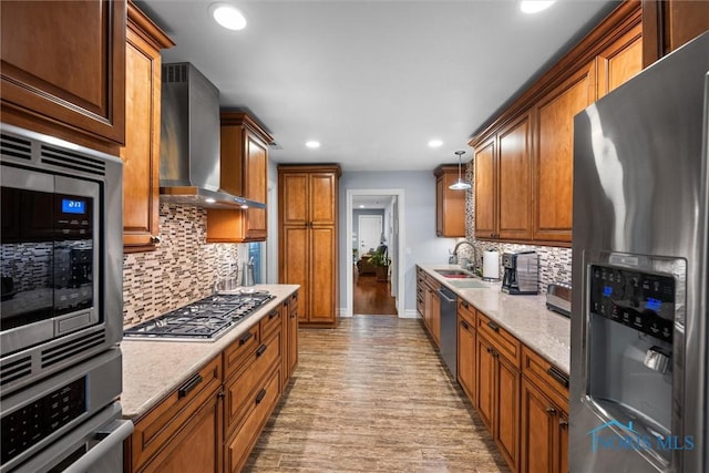 3605 W Laskey Rd, Toledo, OH 43623 - kitchen featuring stainless steel appliances, wall chimney range hood, light wood finished floors, recessed lighting, and backsplash