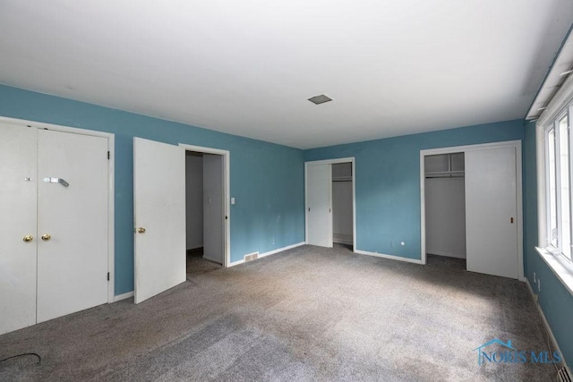 4906 Pine Ridge Rd, Toledo, OH 43615 - unfurnished bedroom featuring multiple closets and carpet floors