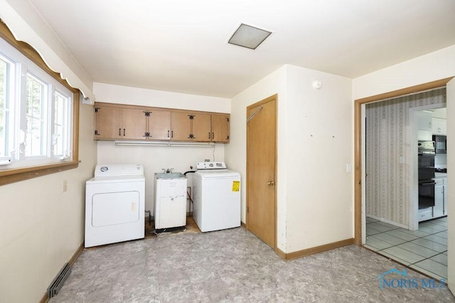 4906 Pine Ridge Rd, Toledo, OH 43615 - laundry room with separate washer and dryer, cabinet space, and light floors