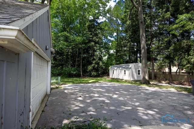 4906 Pine Ridge Rd, Toledo, OH 43615 - view of side of property with a patio area and a storage shed
