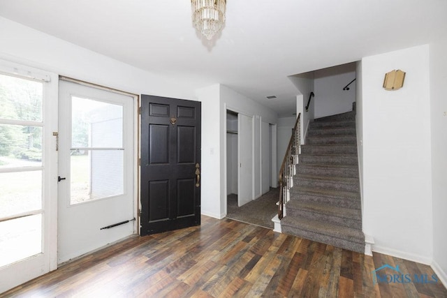 4906 Pine Ridge Rd, Toledo, OH 43615 - foyer entrance with stairway, wood finished floors, and a chandelier