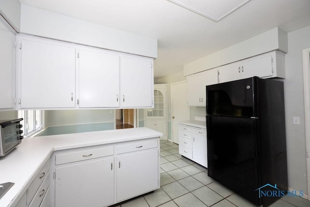 4906 Pine Ridge Rd, Toledo, OH 43615 - kitchen featuring freestanding refrigerator, light countertops, and white cabinetry