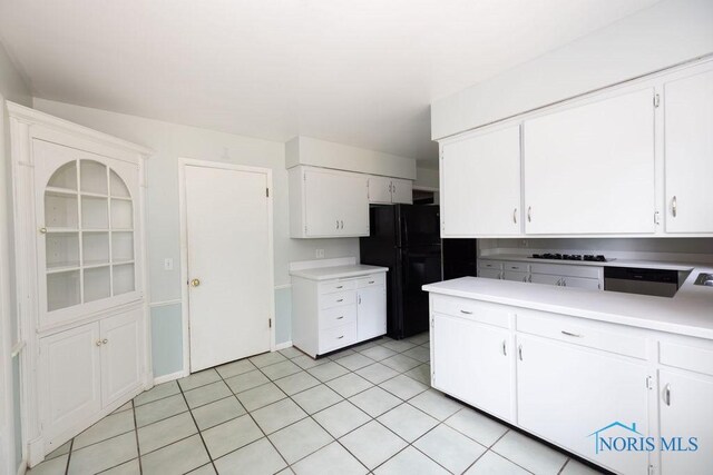 4906 Pine Ridge Rd, Toledo, OH 43615 - kitchen with white cabinets, light countertops, black appliances, and light tile patterned floors