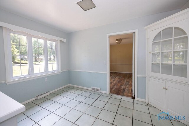 4906 Pine Ridge Rd, Toledo, OH 43615 - unfurnished dining area featuring light tile patterned floors and baseboards