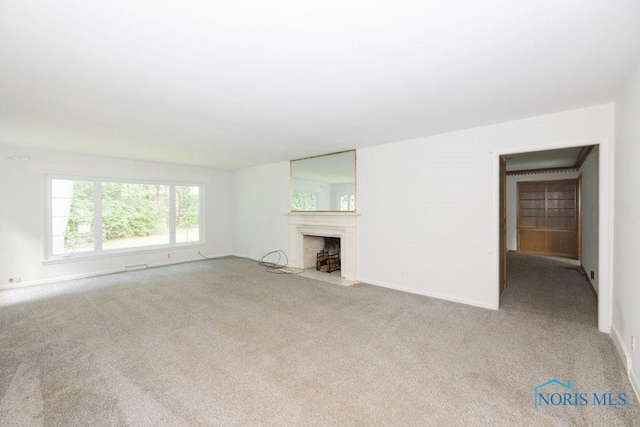 4906 Pine Ridge Rd, Toledo, OH 43615 - unfurnished living room featuring carpet floors and a fireplace with flush hearth