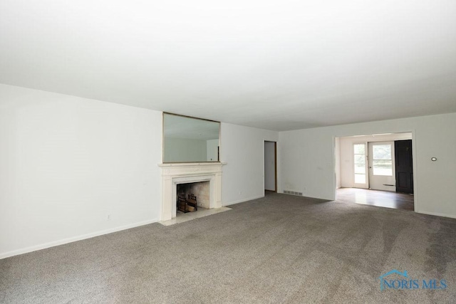 4906 Pine Ridge Rd, Toledo, OH 43615 - unfurnished living room featuring carpet floors and a fireplace with flush hearth