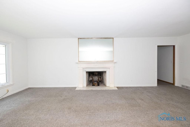 4906 Pine Ridge Rd, Toledo, OH 43615 - unfurnished living room with a fireplace with flush hearth and carpet flooring