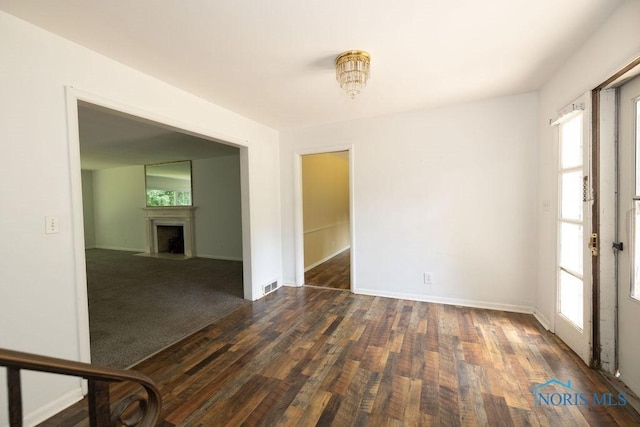 4906 Pine Ridge Rd, Toledo, OH 43615 - unfurnished dining area featuring plenty of natural light, dark wood-type flooring, and a fireplace