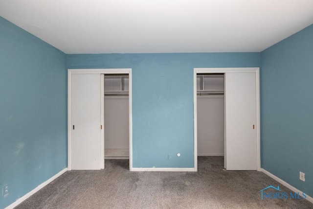4906 Pine Ridge Rd, Toledo, OH 43615 - unfurnished bedroom featuring multiple closets and carpet