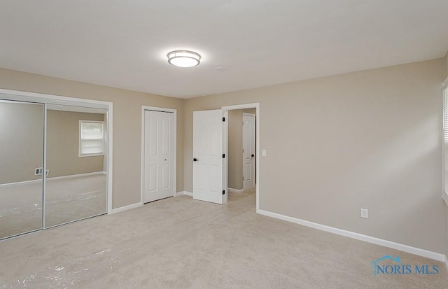 4308 Willis Blvd, Toledo, OH 43623 - unfurnished bedroom with multiple closets and carpet flooring