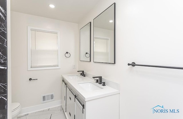 4308 Willis Blvd, Toledo, OH 43623 - bathroom with double vanity, marble look tiles, and recessed lighting
