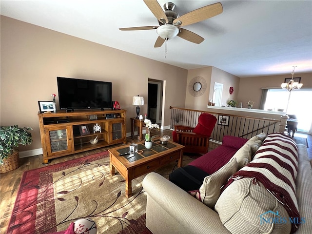 410 Spring St, Upper Sandusky, OH 43351 - living area featuring wood finished floors, a ceiling fan, and a chandelier