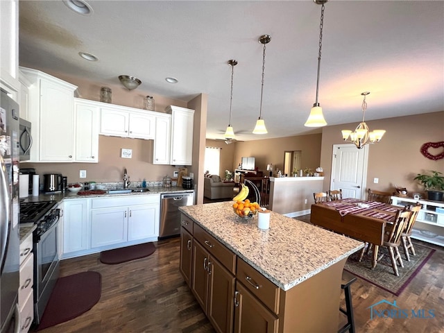 410 Spring St, Upper Sandusky, OH 43351 - kitchen featuring appliances with stainless steel finishes, dark wood-type flooring, a chandelier, a kitchen island, and recessed lighting