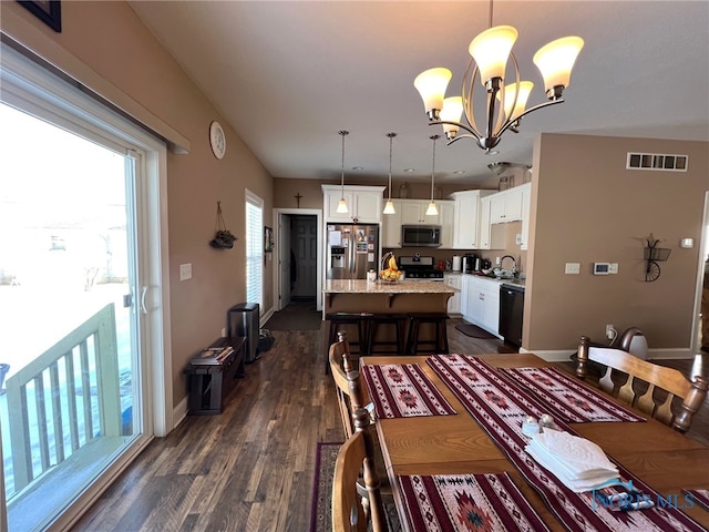410 Spring St, Upper Sandusky, OH 43351 - dining area featuring dark wood finished floors and a chandelier