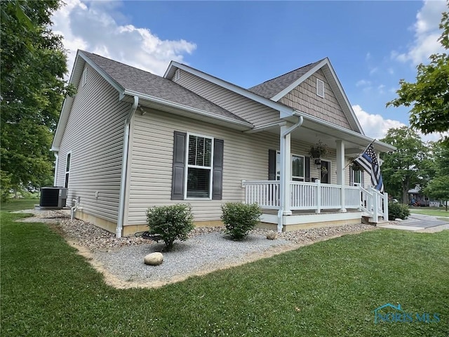 410 Spring St, Upper Sandusky, OH 43351 - view of side of home with covered porch, a lawn, and roof with shingles