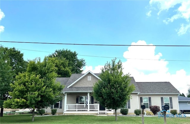 410 Spring St, Upper Sandusky, OH 43351 - view of front of house featuring a porch, a front lawn, and roof with shingles