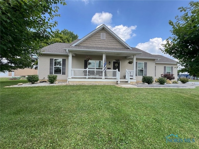 410 Spring St, Upper Sandusky, OH 43351 - view of front of property with covered porch, a front lawn, and roof with shingles