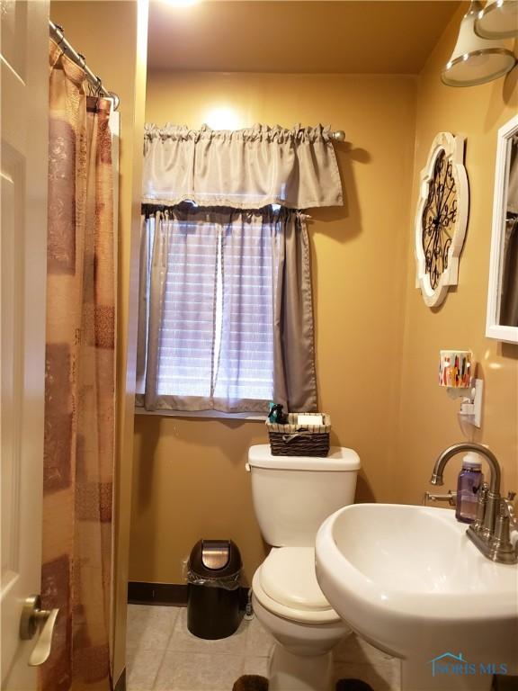254 Fremont St, Elmore, OH 43416 - bathroom with tile patterned flooring and curtained shower