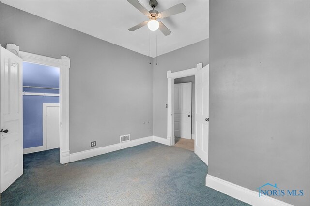 2008 N Main St, Findlay, OH 45840 - unfurnished bedroom featuring carpet flooring, a walk in closet, and ceiling fan