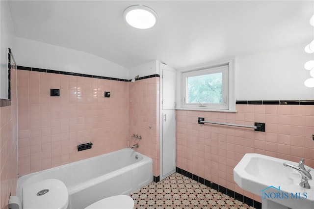 2008 N Main St, Findlay, OH 45840 - full bathroom featuring tile walls, pet washing area, shower / bathtub combination, and a wainscoted wall