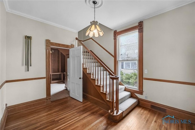 2008 N Main St, Findlay, OH 45840 - stairs featuring plenty of natural light, wood finished floors, a chandelier, and ornamental molding