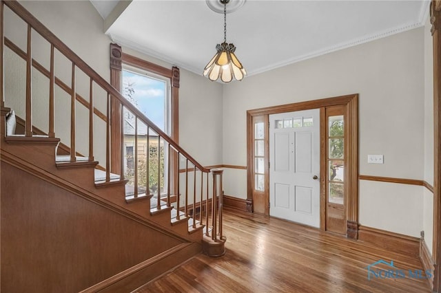 2008 N Main St, Findlay, OH 45840 - entrance foyer with plenty of natural light, wood finished floors, stairs, a chandelier, and ornamental molding