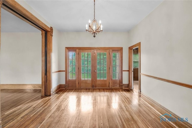 2008 N Main St, Findlay, OH 45840 - empty room featuring wood finished floors, a chandelier, and french doors