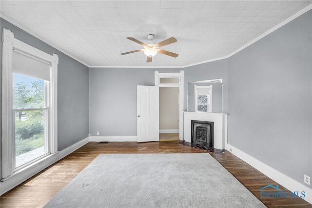 2008 N Main St, Findlay, OH 45840 - unfurnished living room with healthy amount of natural light, ornamental molding, ceiling fan, wood finished floors, and a fireplace with flush hearth