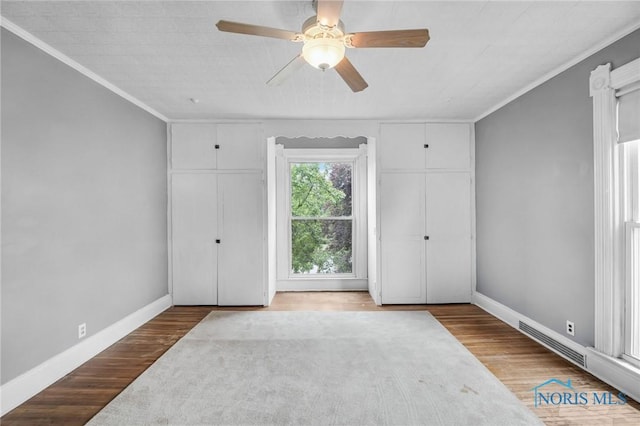 2008 N Main St, Findlay, OH 45840 - unfurnished bedroom featuring ornamental molding, ceiling fan, and wood finished floors