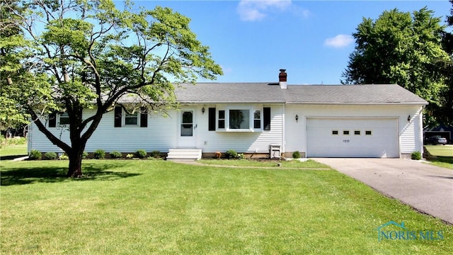 11232 Elm St, Dunbridge, OH 43414 - single story home with concrete driveway, a chimney, an attached garage, and a front yard