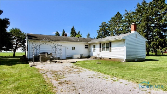 11232 Elm St, Dunbridge, OH 43414 - rear view of property with a patio area, a chimney, and a lawn