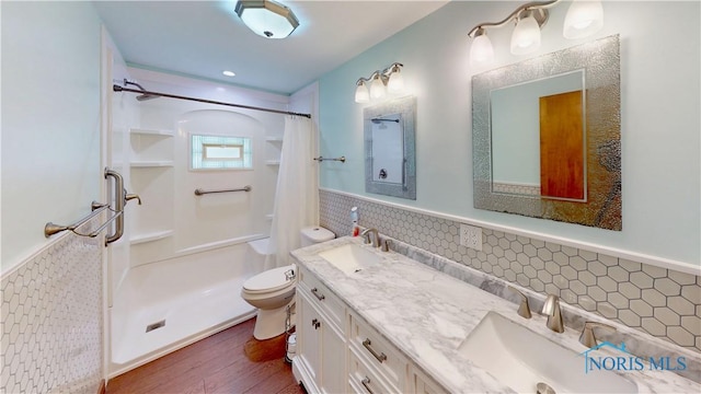 11232 Elm St, Dunbridge, OH 43414 - bathroom featuring a wainscoted wall, wood finished floors, curtained shower, and double vanity