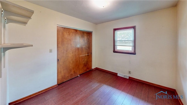 11232 Elm St, Dunbridge, OH 43414 - unfurnished bedroom with dark wood-type flooring and a closet