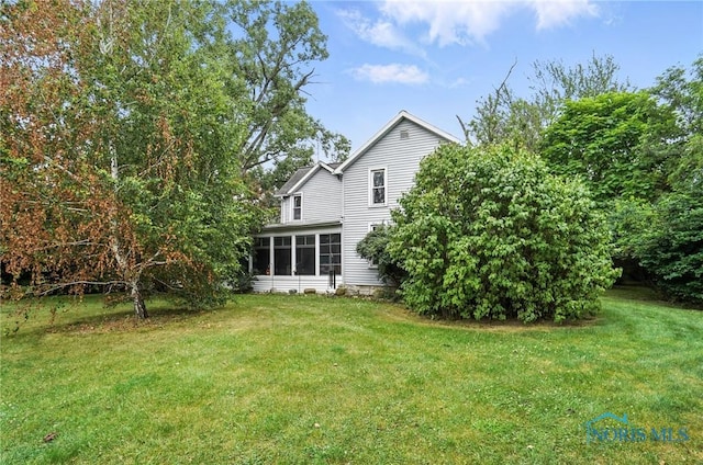 5660 Rd 180, Antwerp, OH 45813 - back of house with a lawn and a sunroom